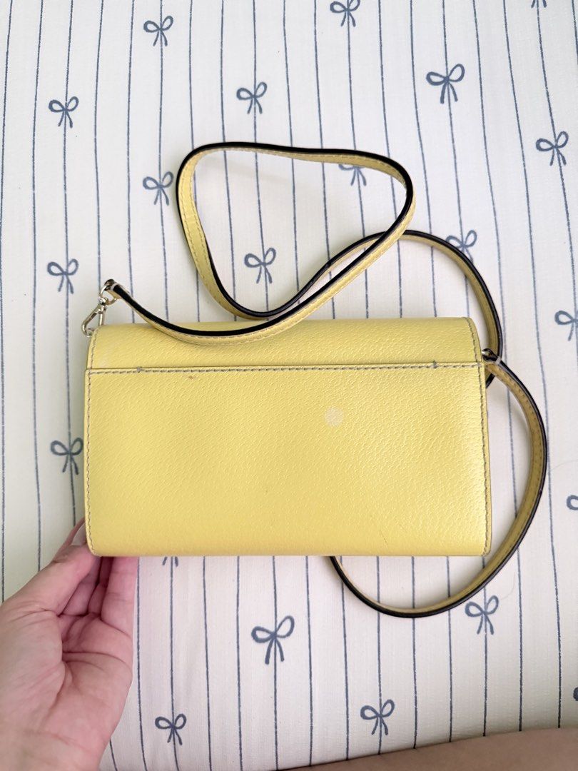 Kate Spade Yellow Leather Wallet on Chain (Category: Luxury Bags & Wallets) located in Cebu City. Submitted by declutterwithvie (Listing ID 1445125073, Image 2). Description: - Authentic Yellow Kate Spade Wallet on Chain (WOC) - Genuine Leather Material - Features a few light marks on the back, clearly shown in photos - Interior includes convenient card slots and a zippered pocket - Detachable strap for versatile carrying options - Ideal for carr