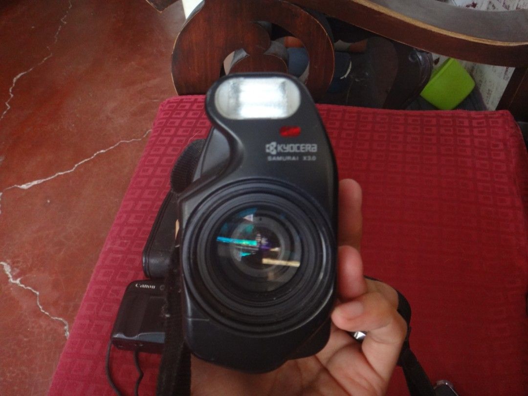 Kyocera Samurai X3.0 35mm Film Camera with Flash (Untested) (Category: Cameras) located in Silang. Submitted by carlodelva46951 (Listing ID 1445071615, Image 1). Description: - Kyocera Samurai X3.0 35mm film camera - Built-in flash - Uses Fujifilm 2CR5 lithium batteries - Strap is attached - Film compartment is open in photos Note: - Has a battery but not working - Have not tried it yet, coz of no battery.