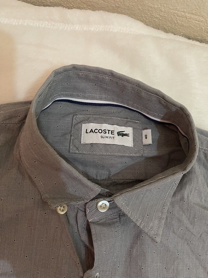 Lacoste Slim Fit Button Down Shirt Grey Size 40 (Category: Tshirts & Polo Shirts ) located in Tuguegarao City. Submitted by elyks11 (Listing ID 1445077518, Image 2). Description: - Brand: Lacoste - Color: Grey - Fit: Slim Fit - Size: 40 - Material: 100% Cotton - Origin: Made in Argentina - Features: Embroidered Lacoste crocodile logo on chest, button cuffs - Style: Smart casual wear.