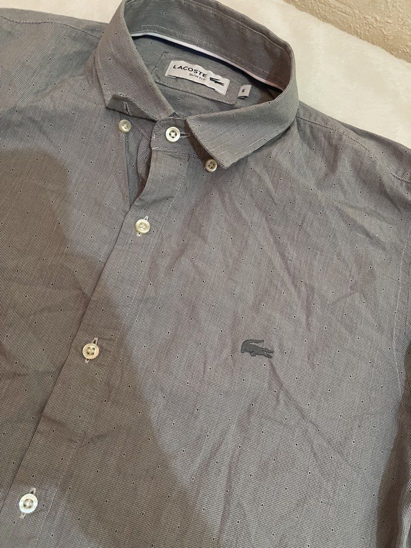 Lacoste Slim Fit Button Down Shirt Grey Size 40 (Category: Tshirts & Polo Shirts ) located in Tuguegarao City. Submitted by elyks11 (Listing ID 1445077518, Image 3). Description: - Brand: Lacoste - Color: Grey - Fit: Slim Fit - Size: 40 - Material: 100% Cotton - Origin: Made in Argentina - Features: Embroidered Lacoste crocodile logo on chest, button cuffs - Style: Smart casual wear.