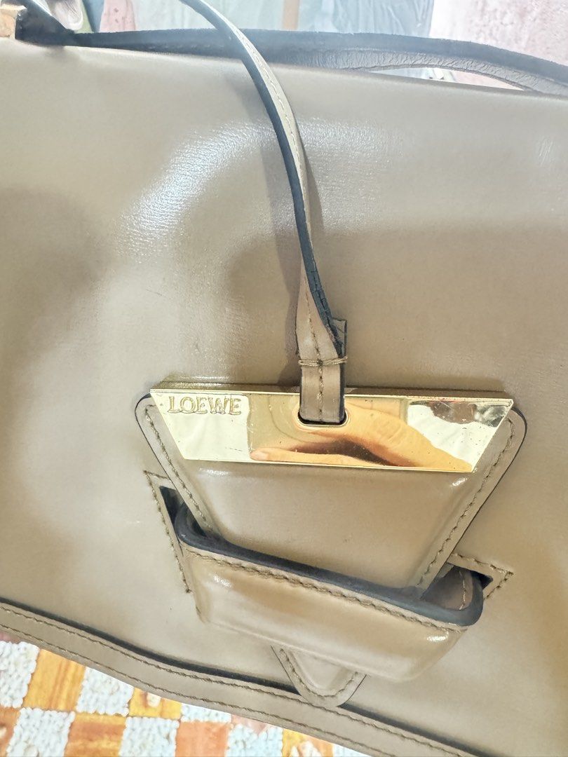 Loewe Puzzle Bag Tan Leather (Category: Luxury Bags & Wallets) located in Manila. Submitted by wildbear.e10374 (Listing ID 1445063100, Image 1). Description: - Authentic Loewe bag - Color: Tan - Material: Leather - Made in Spain - Includes shoulder strap - Multiple interior compartments - Gold hardware.