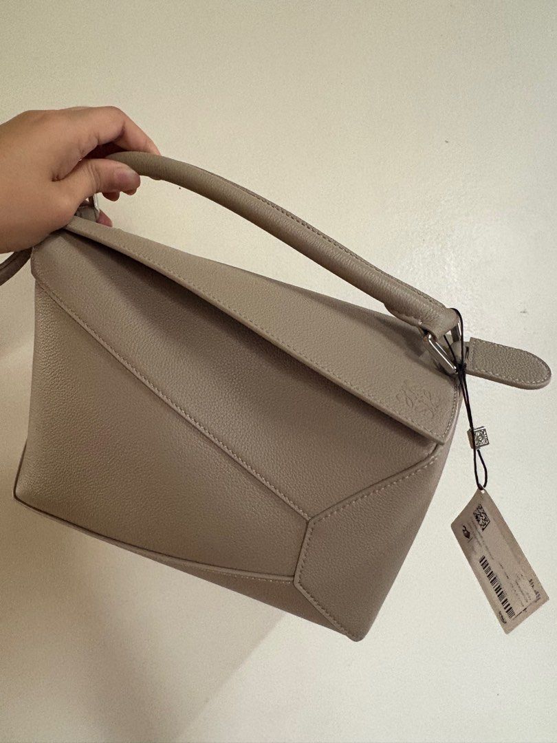 LOEWE Small Puzzle Edge Bag Clay (Category: Luxury Bags & Wallets) located in Pasig City. Submitted by maan008 (Listing ID 1445127777, Image 1). Description: Authentic - purchased from Barcelona Flagship Store with dust bag, box and paper bag included - LOEWE Small Puzzle Edge bag in soft grained calfskin - Color: Clay - Brand new with original tags RFS: extra piece .