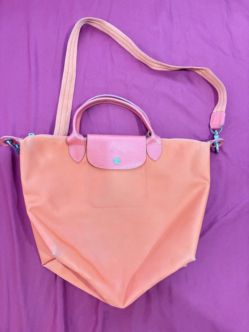 Longchamp Le Pliage Neo Orange Tote Bag (Category: Luxury Bags & Wallets) located in Los Banos. Submitted by tripleceedoubletwo (Listing ID 1445075900, Image 1). Description: - Authentic Orange Longchamp tote bag - Durable nylon body with genuine leather handles and strap - Includes a detachable shoulder strap for versatile carrying - Interior is clean and well-maintained - Ideal for everyday use - Folds flat for convenient storage - Signs of usa