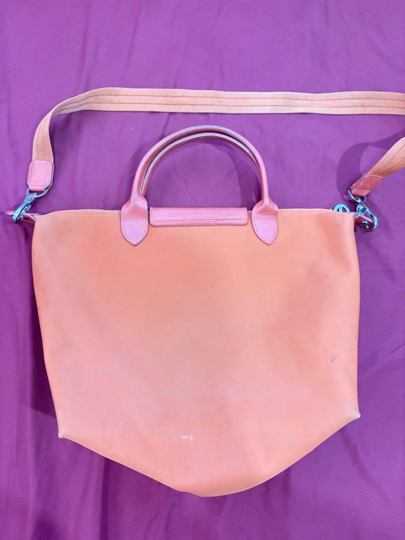 Longchamp Le Pliage Neo Orange Tote Bag (Category: Luxury Bags & Wallets) located in Los Banos. Submitted by tripleceedoubletwo (Listing ID 1445075900, Image 2). Description: - Authentic Orange Longchamp tote bag - Durable nylon body with genuine leather handles and strap - Includes a detachable shoulder strap for versatile carrying - Interior is clean and well-maintained - Ideal for everyday use - Folds flat for convenient storage - Signs of usa