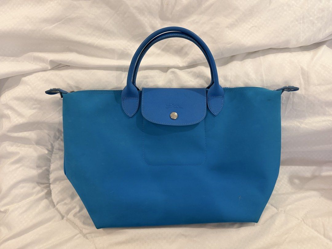 Longchamp Le Pliage Neo Shoulder Bag Blue (Category: Luxury Bags & Wallets) located in Cavite. Submitted by cloudbar99 (Listing ID 1445063351, Image 1). Description: Read for details! (^0^)/ - AUTHENTIC Blue Longchamp Le Pliage Neo bag - Durable nylon body with genuine leather handles and trim - Sleek silver hardware - Detachable shoulder strap included - Minor signs of wear visible in photos - Secure top zipper closure Reasons for selling: declu