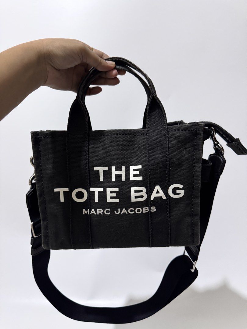 Marc Jacobs The Tote Bag Black Canvas Mini (Category: Luxury Bags & Wallets) located in Davao. Submitted by stellietas (Listing ID 1445119177, Image 3). Description: Size: 9.75L x 7.75H x 4.25W inches No flaws, excellent condition, signs of use only on the canvas minimal fadings. 💯 % original or money back Japan preloved item.