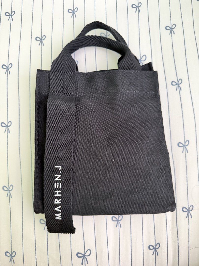 MARHEN.J Original Black Canvas Tote Bag (Category: Tote Bags) located in Cebu City. Submitted by declutterwithvie (Listing ID 1445127893, Image 2). Description: - Authentic Marhen.J tote bag - Color: Black - Material: Canvas - Origin: Made in Korea - Closure: Snap button - Features: Detachable shoulder strap, interior pockets - Design: Clean and simple.