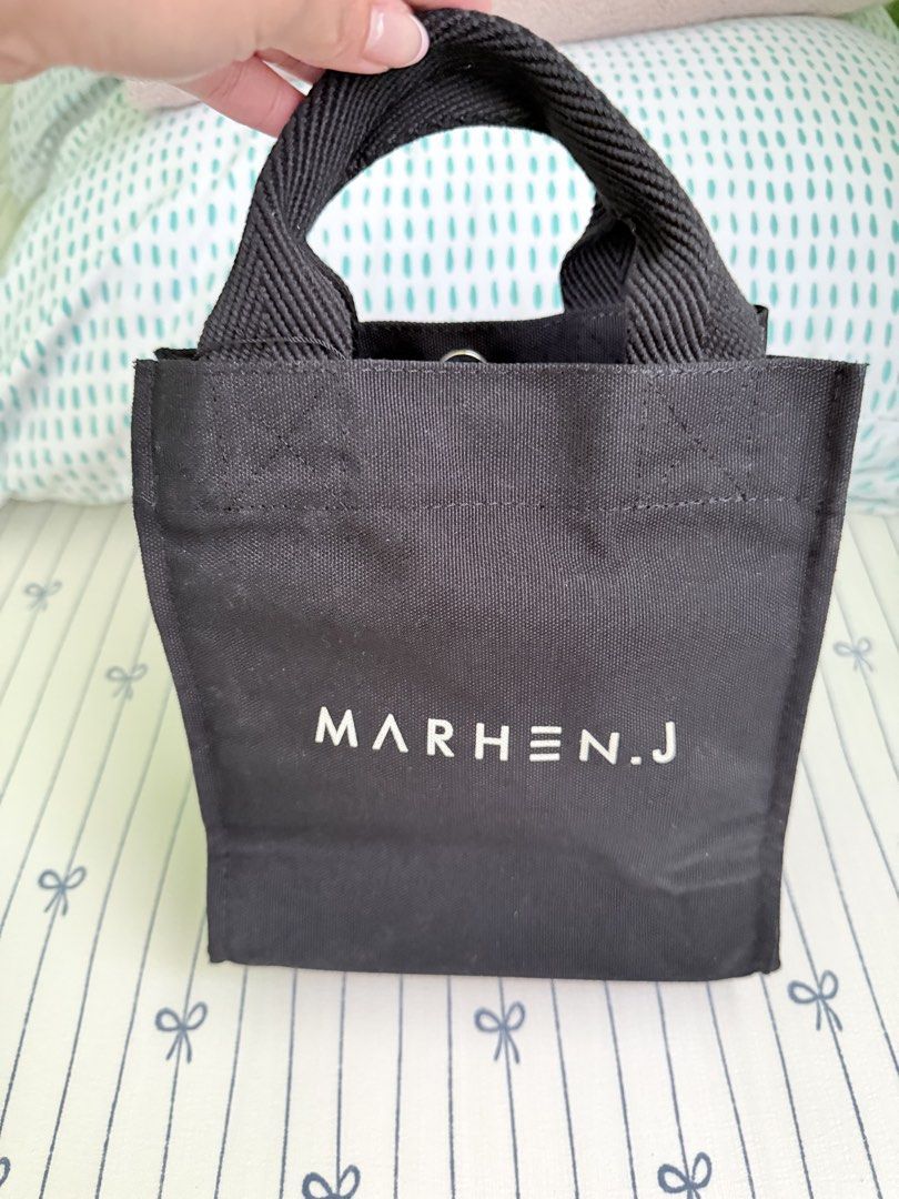 MARHEN.J Original Black Canvas Tote Bag (Category: Tote Bags) located in Cebu City. Submitted by declutterwithvie (Listing ID 1445127893, Image 1). Description: - Authentic Marhen.J tote bag - Color: Black - Material: Canvas - Origin: Made in Korea - Closure: Snap button - Features: Detachable shoulder strap, interior pockets - Design: Clean and simple.