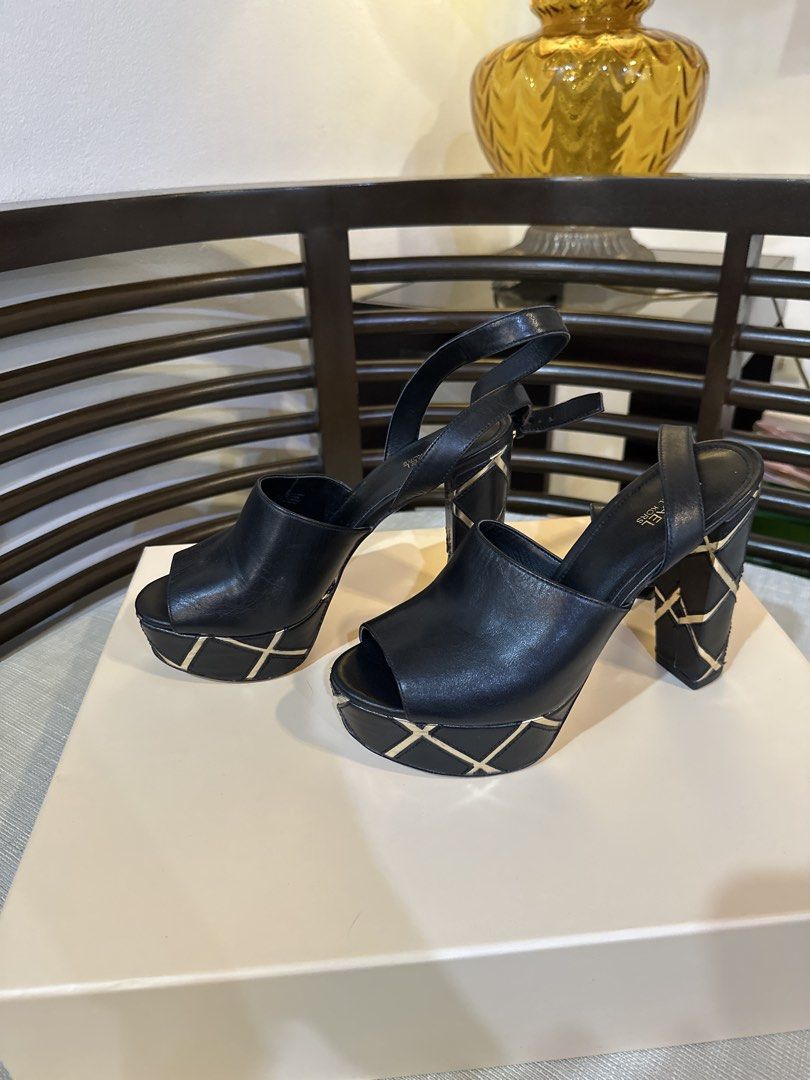 Michael Kors Black Leather Platform Slingback Heels US 6.5 (Category: Heels) located in Pasig City. Submitted by nina.declutter (Listing ID 1445132211, Image 1). Description: - Michael Kors black leather slingback heels - Peep toe design - Chunky platform with gold criss-cross detail - Gold criss-cross pattern on heel - Adjustable ankle strap for a secure fit - Perfect statement heels.