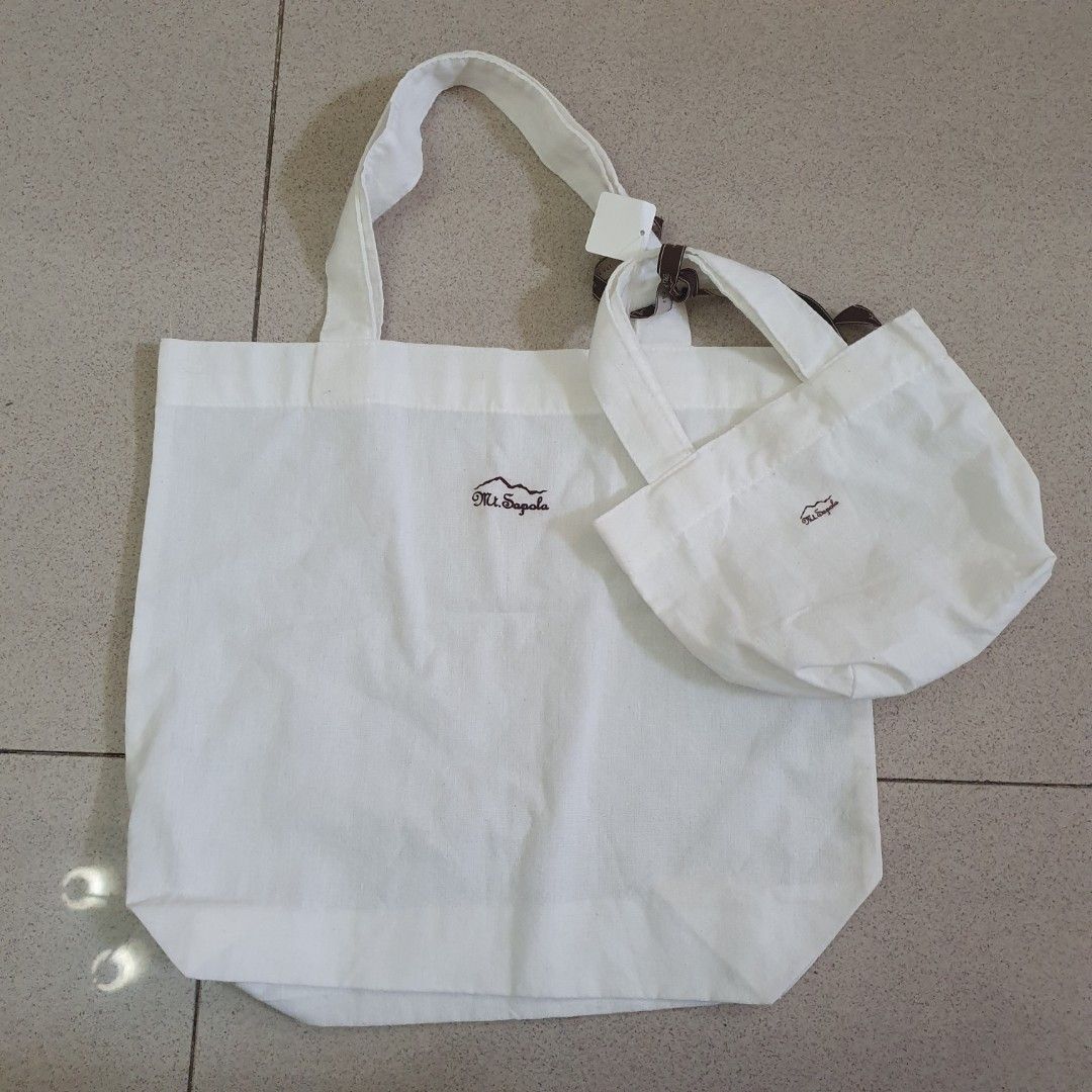Mt. Sapola White Canvas Tote Bag (Category: Tote Bags) located in Paranaque City. Submitted by cobien (Listing ID 1445224084, Image 1). Description: - White canvas tote bag from Mt. Sapola - Features embroidered Mt. Sapola logo on front and flap - Two sturdy handles - Simple and practical for everyday use - Ideal for groceries or carrying essentials.