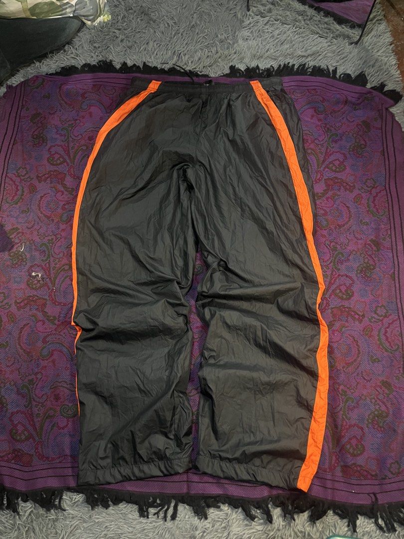 Nike Black Orange Track Pants XL (Category: Joggers) located in Caloocan City. Submitted by leo.noelalonzo (Listing ID 1445215548, Image 2). Description: - Black Nike track pants - Size XL - Orange stripe detail down the sides - Elastic waistband with drawstring - Nike logo on left leg and back - Made in the Philippines - Perfect for sports or casual wear.