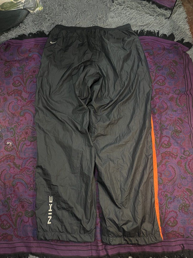 Nike Black Orange Track Pants XL (Category: Joggers) located in Caloocan City. Submitted by leo.noelalonzo (Listing ID 1445215548, Image 1). Description: - Black Nike track pants - Size XL - Orange stripe detail down the sides - Elastic waistband with drawstring - Nike logo on left leg and back - Made in the Philippines - Perfect for sports or casual wear.