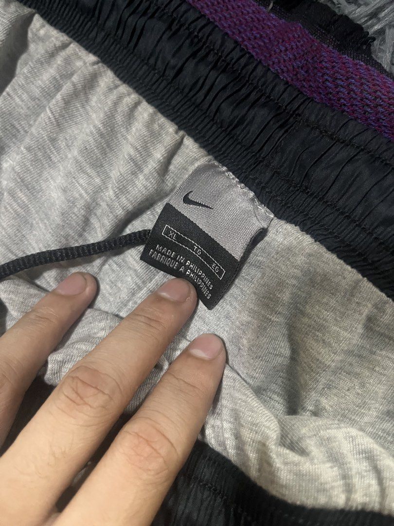 Nike Black Orange Track Pants XL (Category: Joggers) located in Caloocan City. Submitted by leo.noelalonzo (Listing ID 1445215548, Image 3). Description: - Black Nike track pants - Size XL - Orange stripe detail down the sides - Elastic waistband with drawstring - Nike logo on left leg and back - Made in the Philippines - Perfect for sports or casual wear.