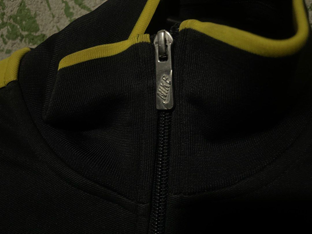 Nike FC Barcelona Track Jacket (Category: Coats, Jackets and Outerwear) located in Manila. Submitted by jofferpari63571 (Listing ID 1445200805, Image 2). Description: - Authentic Nike track jacket - Features FC Barcelona crest - Black and yellow colorway - Full zip closure - Nike swoosh logo - Ideal for football enthusiasts.