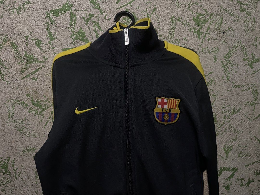 Nike FC Barcelona Track Jacket (Category: Coats, Jackets and Outerwear) located in Manila. Submitted by jofferpari63571 (Listing ID 1445200805, Image 1). Description: - Authentic Nike track jacket - Features FC Barcelona crest - Black and yellow colorway - Full zip closure - Nike swoosh logo - Ideal for football enthusiasts.