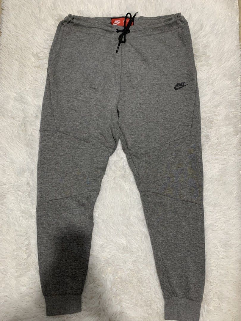 Nike Tech Fleece Grey Jogger Pants XL (Category: Joggers) located in Iba. Submitted by thriftcoyan (Listing ID 1445181639, Image 1). Description: - Grey Nike Tech Fleece Joggers - Size: XL -36-38 -Length 39 - Features classic Nike Swoosh logo - Adjustable drawstring waist - Ribbed cuffs for a snug fit - Ideal for casual wear or workouts - Made in China -Issue print ng swoosh.