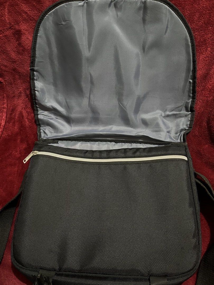 Nikon Black Messenger Camera Bag (Category: Camera Bags & Carriers) located in La Trinidad. Submitted by whatnotcollections (Listing ID 1445177776, Image 3). Description: - Black Nikon messenger bag - Padded shoulder strap for comfort - Thick foam padding on the main compartment. - Front flap with two buckle closures - Durable material - Ideal for camera gear or everyday essentials. - Inside detachable dividers not included. - Can also be used as