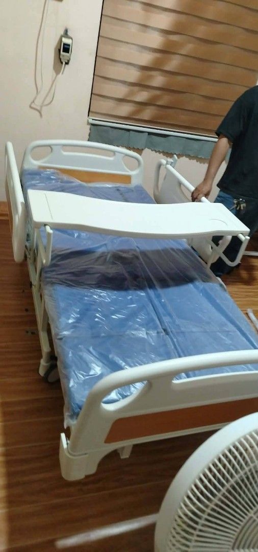 nursing bed manual 7funtion (Category: Medical Supplies & Tools) located in Manila. Submitted by brightflower_273879 (Listing ID 1445050229, Image 1). Description: - Adjustable hospital bed for home care needs - Includes a removable tray table - Features a blue mattress cover - Sturdy and functional design - Ready for pickup.