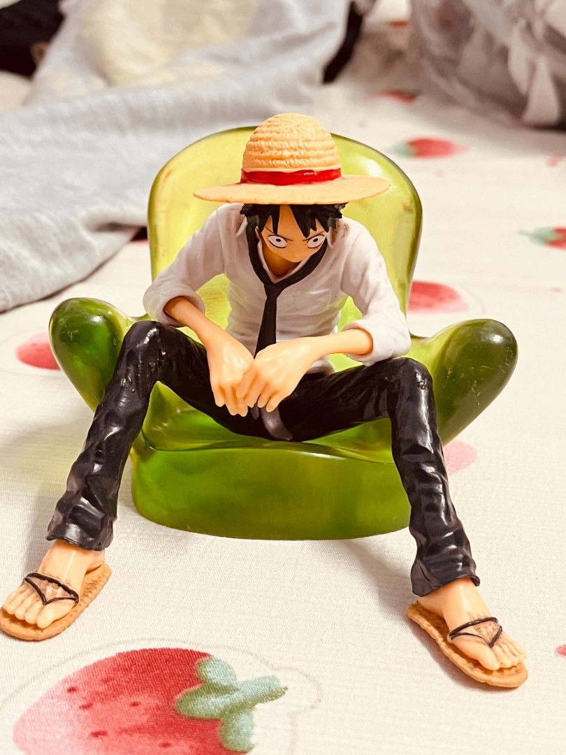 One Piece Monkey D. Luffy Figure Sitting on Chair (Category: Figurines & Statues) located in Manila. Submitted by joanngoter49528 (Listing ID 1445231987, Image 2). Description: - Monkey D. Luffy figure - Sitting pose on a green chair - Iconic straw hat, white shirt, black pants, and sandals - Highly detailed craftsmanship - Ideal for anime collectors and display.