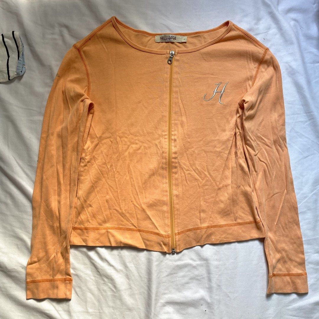 Orange Long Sleeve Zip Up Cardigan (Category: Coats, Jackets and Outerwear) located in Manila. Submitted by _angljpsc (Listing ID 1445179720, Image 1). Description: - Orange long sleeve cardigan - MEDIUM-LARGE SIZE - Zip-up front closure - Soft cotton blend material - Ideal for layering - Subtle stitched detail on hem and cuffs.