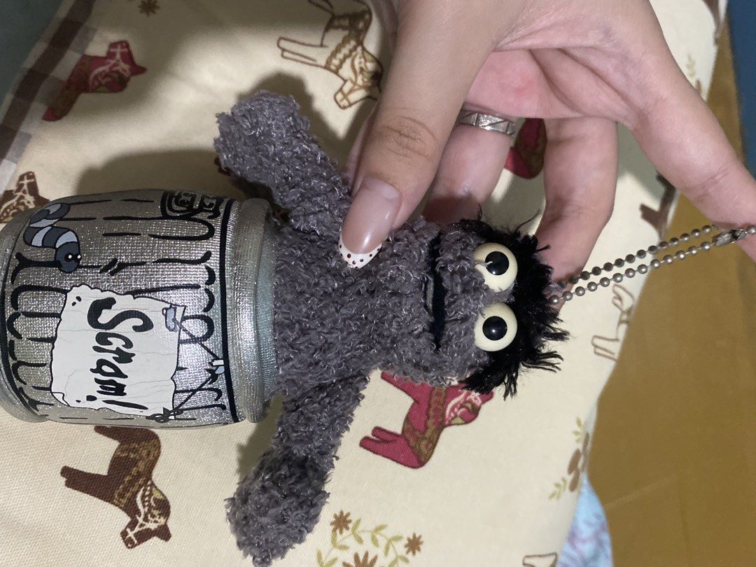 Oscar the Grouch Trash Can Plush Keychain (Category: Plushies & Soft Toys) located in Cagayan de Oro. Submitted by caga67813 (Listing ID 1445164987, Image 1). Description: - Adorable Oscar the Grouch plush keychain. - Features his signature trash can. - Includes a durable metal ball chain. - Ideal accessory for bags, backpacks, or keys. - Manufactured in China..