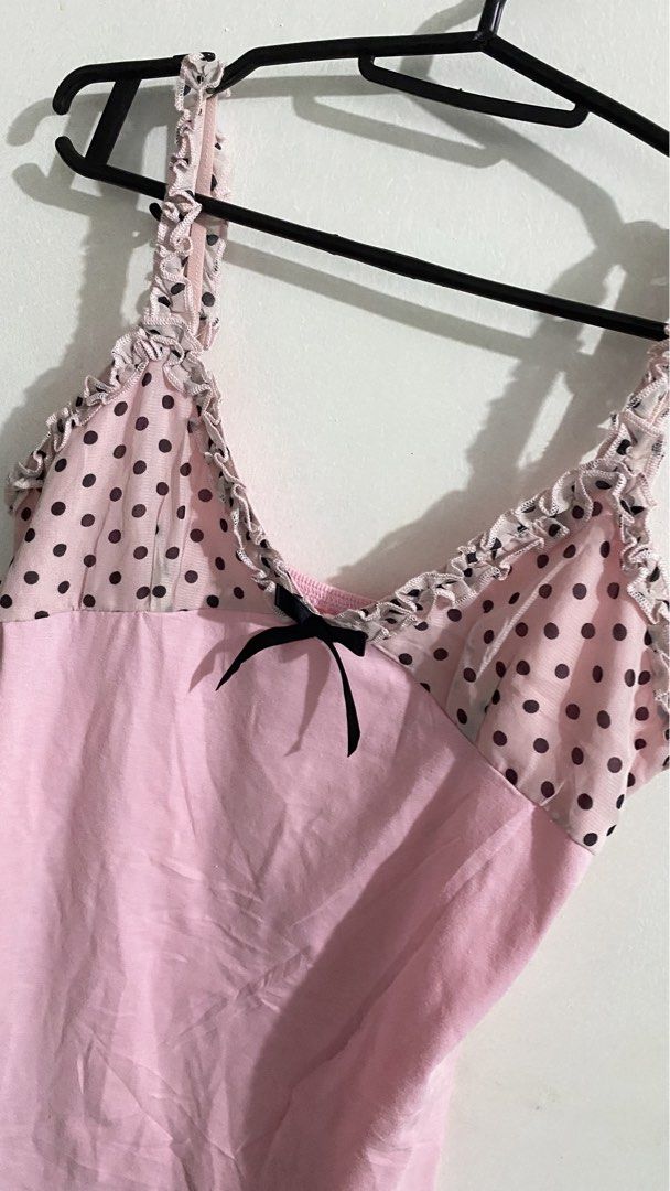 Pink Polka Dot Cami Top with Ruffle Trim (Category: Sleeveless) located in Iloilo. Submitted by kumiyuiz (Listing ID 1445190460, Image 2). Description: mine — 150 steal — 250 lock — 450(au) - Adorable pink camisole - Polka dot overlay on the bust - Sweet black bow detail - Ruffled trim along neckline and straps - Adjustable spaghetti straps - Perfect for layering or standalone wear.
