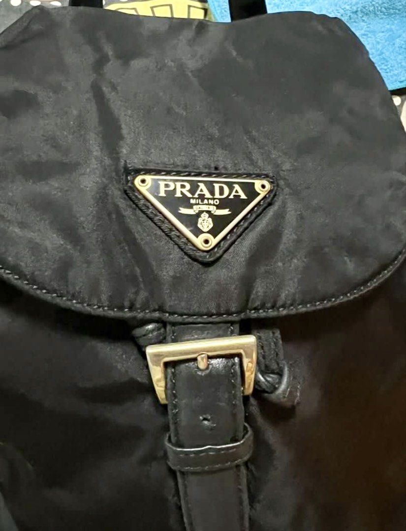 Prada Tessuto Vela Chain Mini Backpack Black (Category: Luxury Bags & Wallets) located in Quezon City. Submitted by letsdeclutter101 (Listing ID 1445134414, Image 3). Description: - Authentic Prada Tessuto Vela Chain Mini Backpack - Color: Black - Material: Nylon with leather trim - Hardware: Gold chain straps - Closure: Drawstring with buckle strap - Size: Small and compact - Perfect for everyday use.