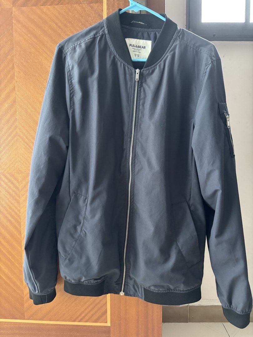 Pull&Bear Bomber Jacket (Category: Coats, Jackets and Outerwear) located in Singapore. Submitted by kitty_loo4572 (Listing ID 1445061495, Image 2). Description: - Brand: Pull&Bear - Color: Dark Navy - Style: Bomber Jacket - Closure: Zip-up front - Pockets: Zipped pocket on left sleeve, two side pockets - Occasion: Casual wear - Styling: Easy to style.