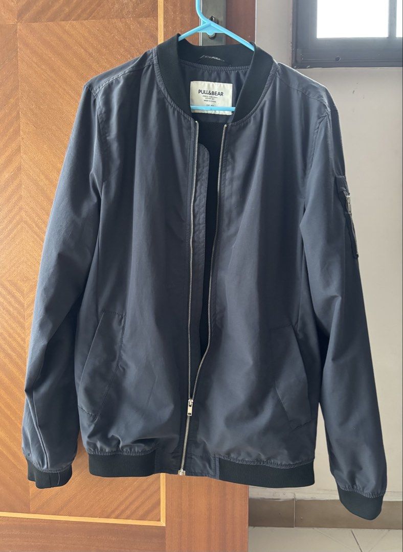 Pull&Bear Bomber Jacket (Category: Coats, Jackets and Outerwear) located in Singapore. Submitted by kitty_loo4572 (Listing ID 1445061495, Image 1). Description: - Brand: Pull&Bear - Color: Dark Navy - Style: Bomber Jacket - Closure: Zip-up front - Pockets: Zipped pocket on left sleeve, two side pockets - Occasion: Casual wear - Styling: Easy to style.