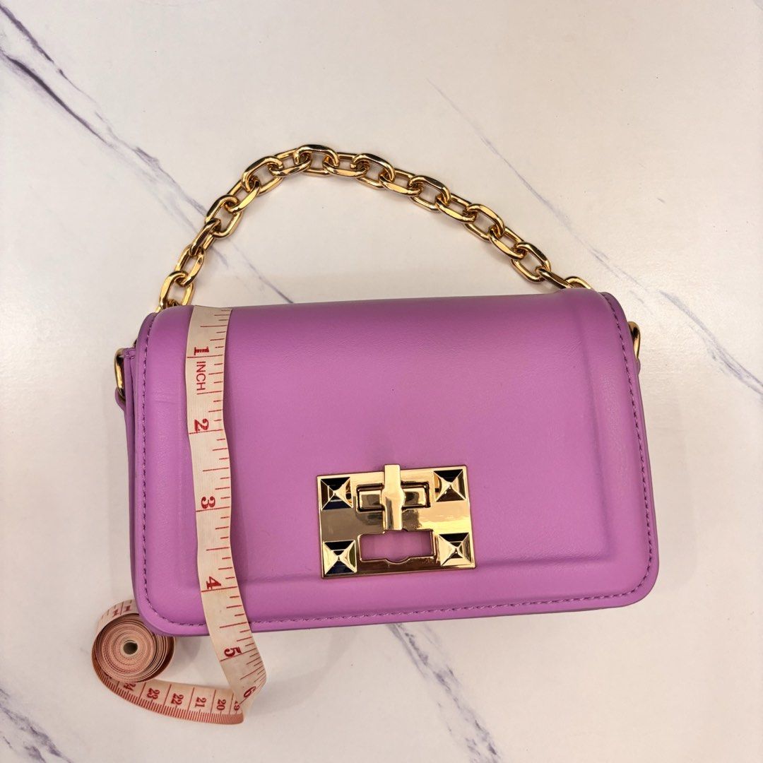 Purple Mini Purse/Crossbody Bag (Category: Purses & Pouches) located in Cainta. Submitted by angeli.6229 (Listing ID 1445103711, Image 3). Description: - Purple mini bag - Features a stylish gold chain strap - Secure gold clasp closure - Compact size: approximately 6 inches wide - Ideal for carrying your essentials - Great for evening events or adding a vibrant touch to any outfit.