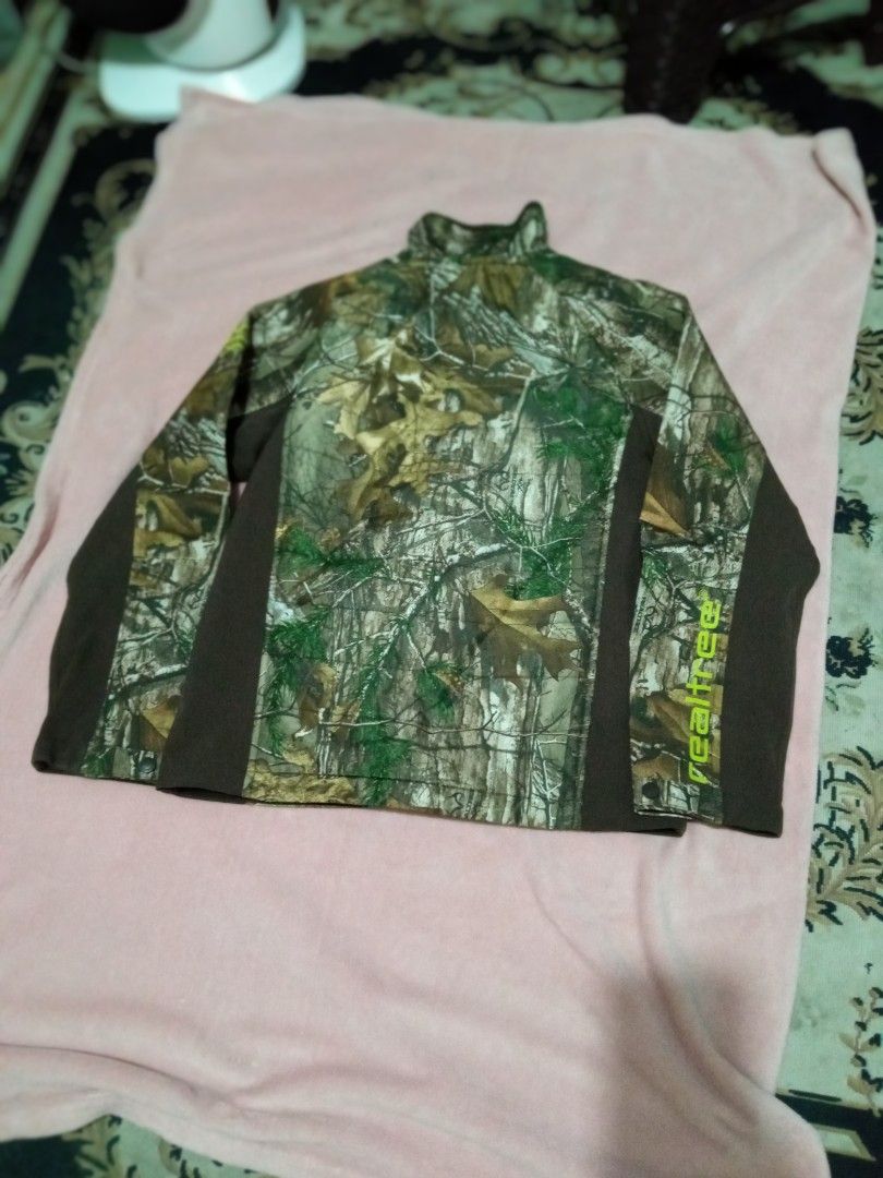 Realtree Camo Fleece Jacket (Category: Coats, Jackets and Outerwear) located in Manila. Submitted by studiozero51579 (Listing ID 1445071450, Image 2). Description: - Authentic Realtree camouflage jacket - Stylish brown panels on sides and sleeves - Full zip front with a comfortable stand-up collar - Smooth, dark interior lining for comfort - Features the iconic Realtree logo on the sleeve and inside - Ideal for hunting, hiking, or everyday casual