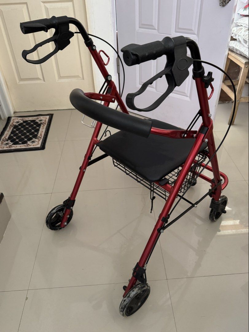 Red Rollator Walker with Seat, Footrest, and Basket (Category: Wheelchairs) located in Cavite. Submitted by mjpv22 (Listing ID 1445068916, Image 3). Description: Actual pic posted - Red walker with built-in cushioned seat, footrest, and storage basket - With hand brakes for enhanced safety - With carabiner hooks for hanging items - With bottle holder - Smooth-rolling wheels, still has plastic as seen in photos - Foldable - Bought for ~4k - Only u