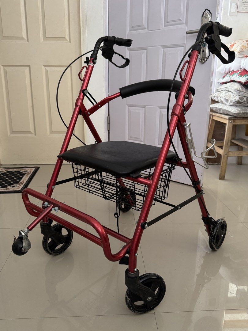 Red Rollator Walker with Seat, Footrest, and Basket (Category: Wheelchairs) located in Cavite. Submitted by mjpv22 (Listing ID 1445068916, Image 2). Description: Actual pic posted - Red walker with built-in cushioned seat, footrest, and storage basket - With hand brakes for enhanced safety - With carabiner hooks for hanging items - With bottle holder - Smooth-rolling wheels, still has plastic as seen in photos - Foldable - Bought for ~4k - Only u