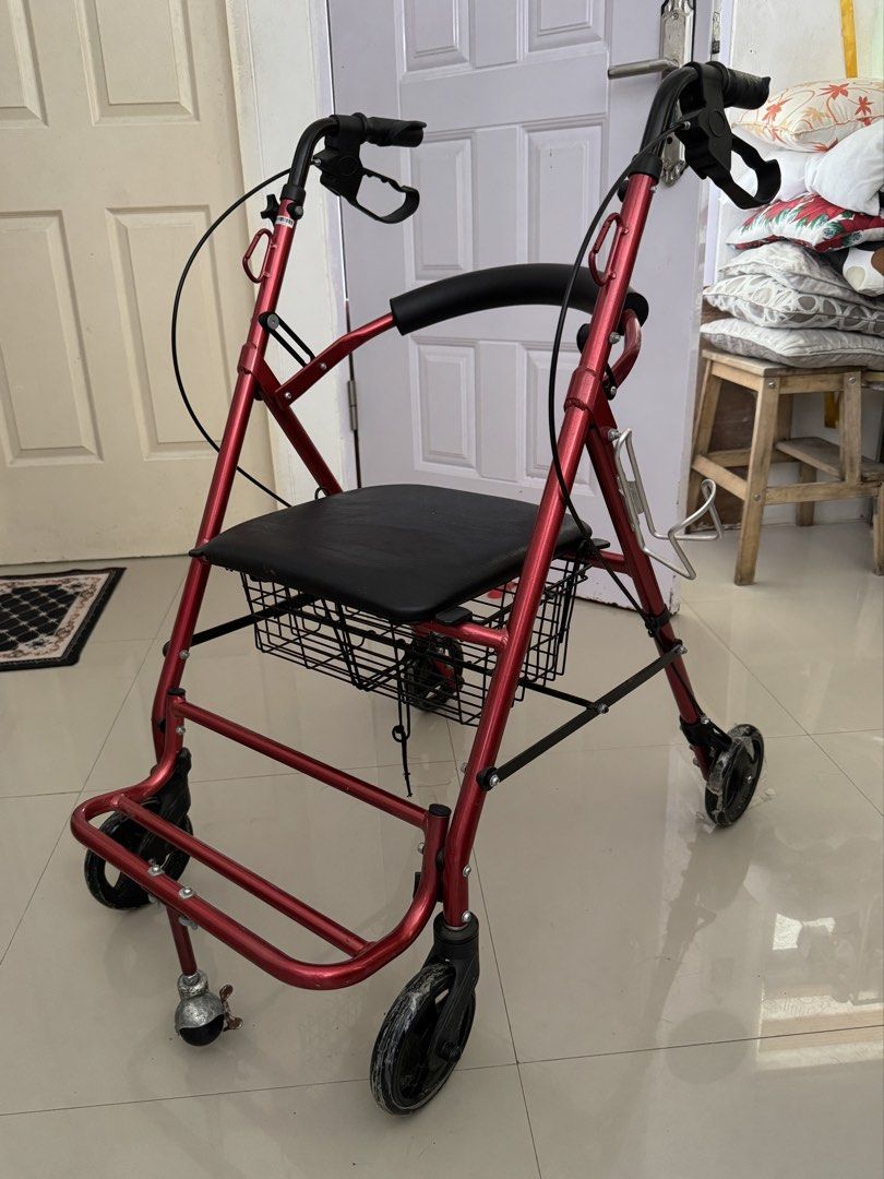 Red Rollator Walker with Seat, Footrest, and Basket (Category: Wheelchairs) located in Cavite. Submitted by mjpv22 (Listing ID 1445068916, Image 1). Description: Actual pic posted - Red walker with built-in cushioned seat, footrest, and storage basket - With hand brakes for enhanced safety - With carabiner hooks for hanging items - With bottle holder - Smooth-rolling wheels, still has plastic as seen in photos - Foldable - Bought for ~4k - Only u