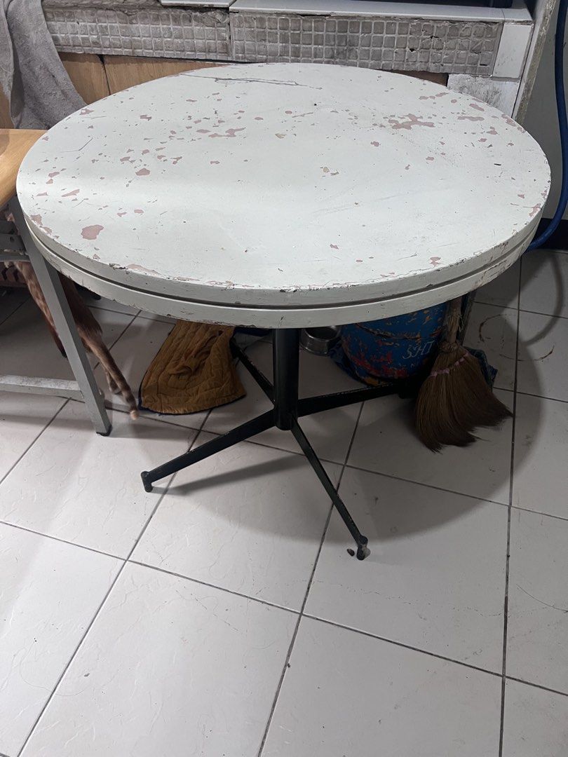 Round White Table with Black Metal Base (Category: Tables & Sets) located in Pasig City. Submitted by mavrugbys_123 (Listing ID 1445200608, Image 2). Description: - Round table with a white top - Black metal base with four sturdy legs - Paint chipped in some areas, showing normal wear and tear - Ideal for small spaces or as a functional side table — Dimensions 84 cm (diameter), 80 cm (height) .