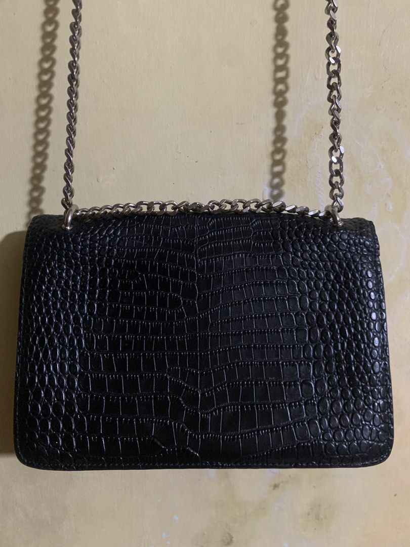 Saint Laurent Black Croc Embossed Chain Shoulder Bag (Category: Luxury Bags & Wallets) located in Legazpi City. Submitted by casanibrah33153 (Listing ID 1445099718, Image 2). Description: - Black croc-embossed leather shoulder bag by Saint Laurent - Signature silver YSL logo on the front - Elegant chain strap - Interior zip pocket and card slots for organization - Engraved 'Saint Laurent Paris' zipper pull - Versatile for both evening events and 