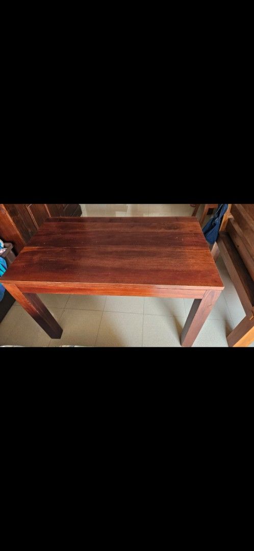 Solid Wood Dining Table (Category: Tables & Sets) located in Singapore. Submitted by KellyRR (Listing ID 1445091498, Image 1). Description: Teak wood table. Dimensions: 47 inch (L) by 28 inch (B) by 31 inch (H) Lightly used. Good condition. Can sit 4 people comfortably. No chair included. Used as a secondary table to our dining table. Selling as no longer needed as we moved and only needed 1 dining table. .