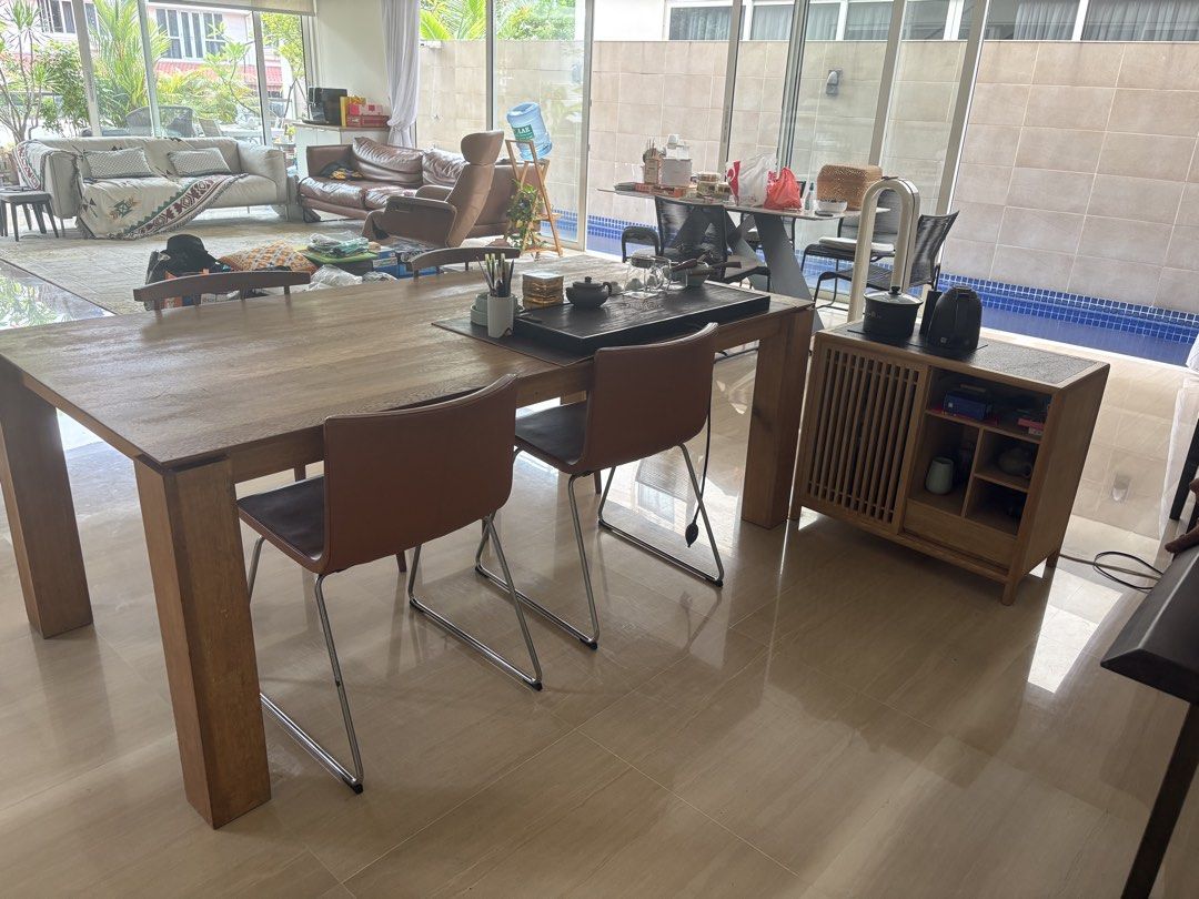 Solid wood table (Category: Tables & Sets) located in Singapore. Submitted by swiftfish.e0bbde (Listing ID 1445069289, Image 2). Description: An elegant and simple wooden table, Length:2 m ,width:1 m The tabletop shows signs of use. As it is made of solid wood, it can be polished or covered with placemats. 2 wooden Chairs ：$30， 2 Leather chairs: $35 Tea tray and Side tea tables are priced .separately..