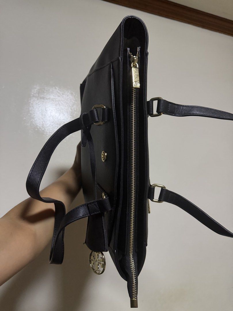 Tory Burch Robinson Black Leather Tote Bag (Category: Luxury Bags & Wallets) located in Manila. Submitted by jennies_prelovedxmurayta (Listing ID 1445134213, Image 3). Description: - Classic black tote bag - Durable Saffiano leather - Elegant gold hardware - Secure zip-top closure - Convenient back zip pocket - Protective metal studs on the bottom - Comfortable shoulder straps - Ideal for daily use and work.