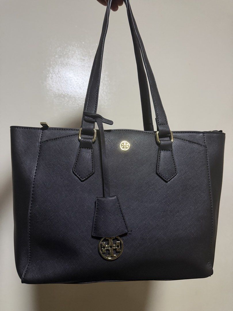 Tory Burch Robinson Black Leather Tote Bag (Category: Luxury Bags & Wallets) located in Manila. Submitted by jennies_prelovedxmurayta (Listing ID 1445134213, Image 1). Description: - Classic black tote bag - Durable Saffiano leather - Elegant gold hardware - Secure zip-top closure - Convenient back zip pocket - Protective metal studs on the bottom - Comfortable shoulder straps - Ideal for daily use and work.