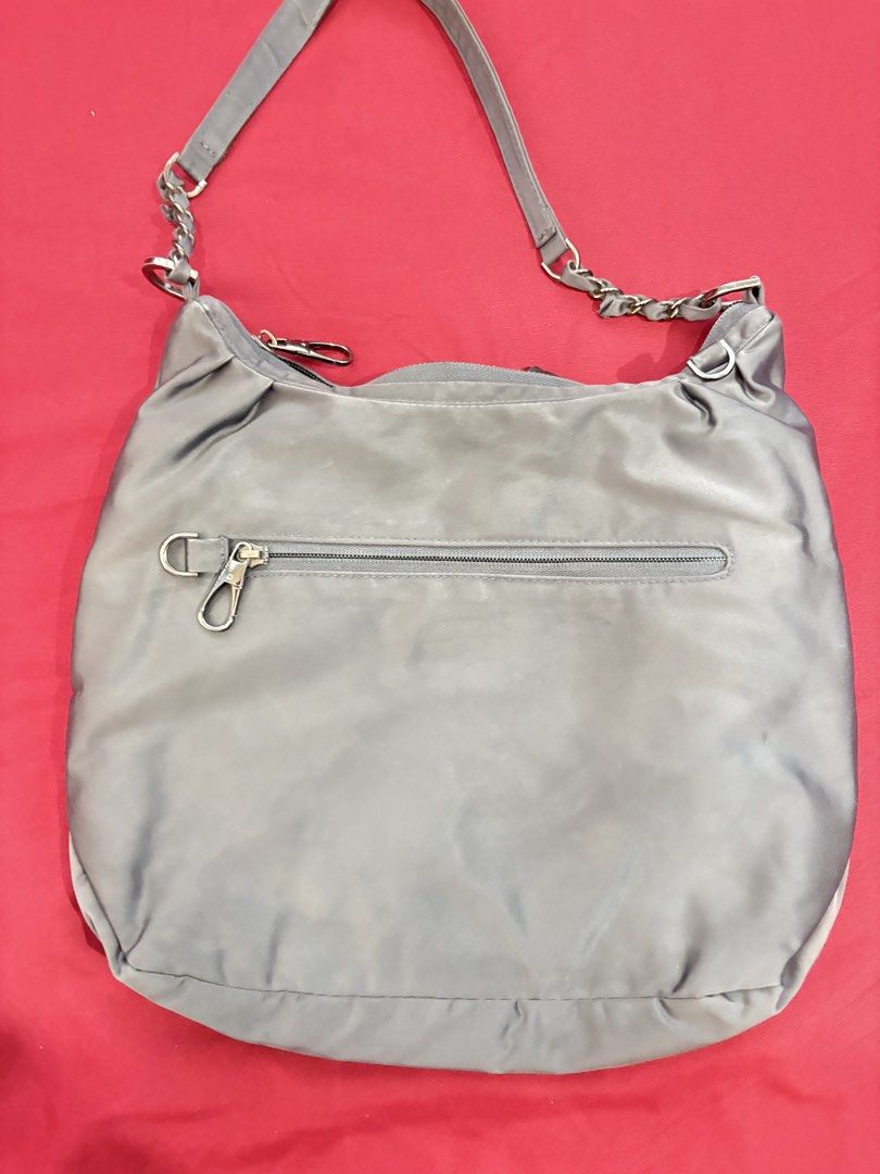 Travelon Grey Nylon Shoulder Bag with Adjustable Strap (Category: Shoulder Bags) located in Los Banos. Submitted by tripleceedoubletwo (Listing ID 1445076778, Image 2). Description: - Grey Travelon shoulder bag - Durable nylon material - Front pocket with snap closure - Zippered back pocket - Interior shows some stains - Detachable and adjustable shoulder strap - Perfect for everyday use or travel - Dimensions: 13 x 3 x 11 inches - MOP: Gcash or 