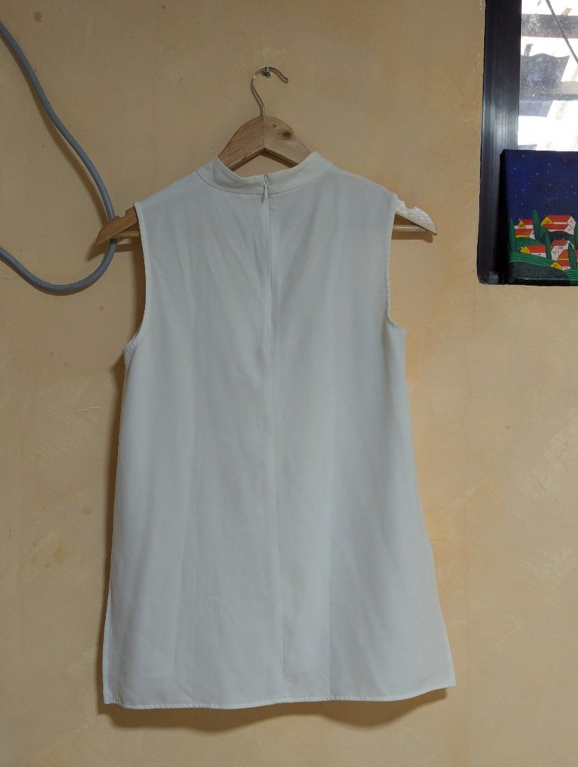 UNIQLO MOCK NECK WHITE TOP (Category: Blouses) located in Rizal. Submitted by smyb0925 (Listing ID 1445115881, Image 2). Description: flaw: black dot at the back (maybe pen ink?) no other flaws seldom used good for casual and officewear.