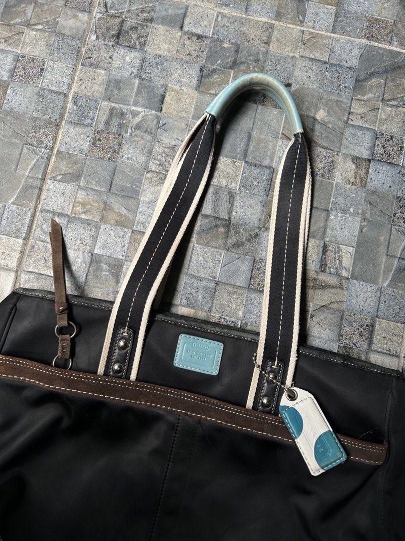 Vintage Coach Hampton Nylon tote bag (Category: Tote Bags) located in Quezon City. Submitted by commonwealthpickerph (Listing ID 1445137687, Image 2). Description: Vintage Coach Hampton Nylon tote bag - 20 width // 12 length - Material: Black nylon with brown leather trim - Accents: Light blue on handles and matching luggage tag - Interior: Multiple compartments for organization - Straps: Comfortable for carrying - Style: Great everyday tote bag 