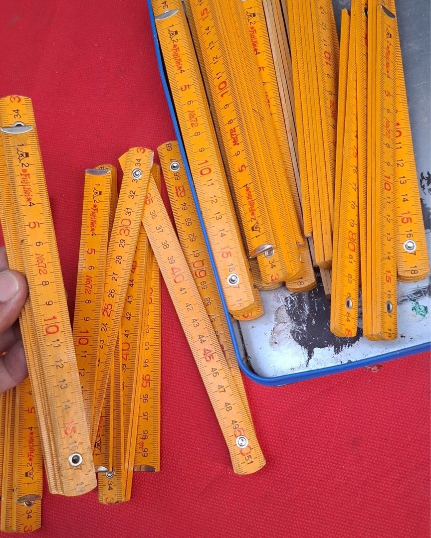 Vintage Wooden Folding Ruler - 2 Meter (Category: Stationery & School Supplies) located in Quezon City. Submitted by eilgaraje (Listing ID 1445191370, Image 2). Description: - Vintage wooden folding ruler - Approximately 2 meters long when fully extended - Classic yellow color - Durable metal hinges - Shows some marks and wear from use, adding to its vintage charm - Fully functional and works well - Ideal for various measuring projects.