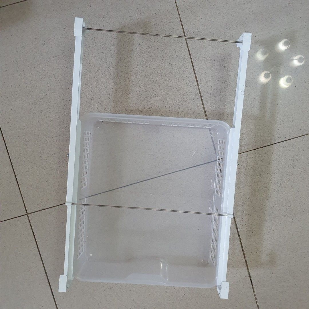 Under shelf drawer Basket (Category: Storage Boxes & Baskets) located in Paranaque City. Submitted by cobien (Listing ID 1445221338, Image 2). Description: - Adjustable white frame with removable plastic basket. - Basket dimensions: 14 x 12.5 inches. - Frame dimensions: 33.5 x 37.5 cm. - Perfect organizer in the cabinet or refrigerator. - Features easy slide-in and slide-out functionality. - Built with sturdy construction for durability..
