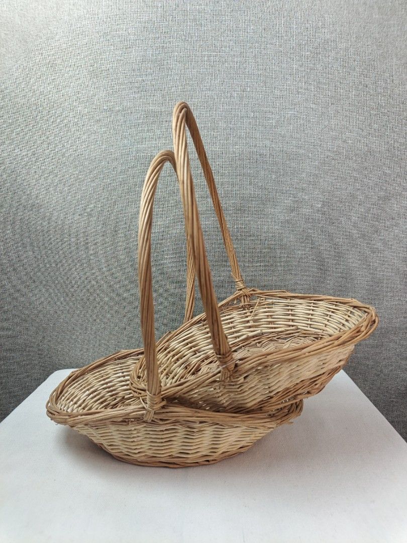 Wicker Basket with Handle - Set of 2 (Category: Storage Boxes & Baskets) located in Baguio. Submitted by rustyribbon (Listing ID 1445100713, Image 1). Description: - Set of two woven wicker baskets - Natural light brown color - Oval shape with tall, curved handles .