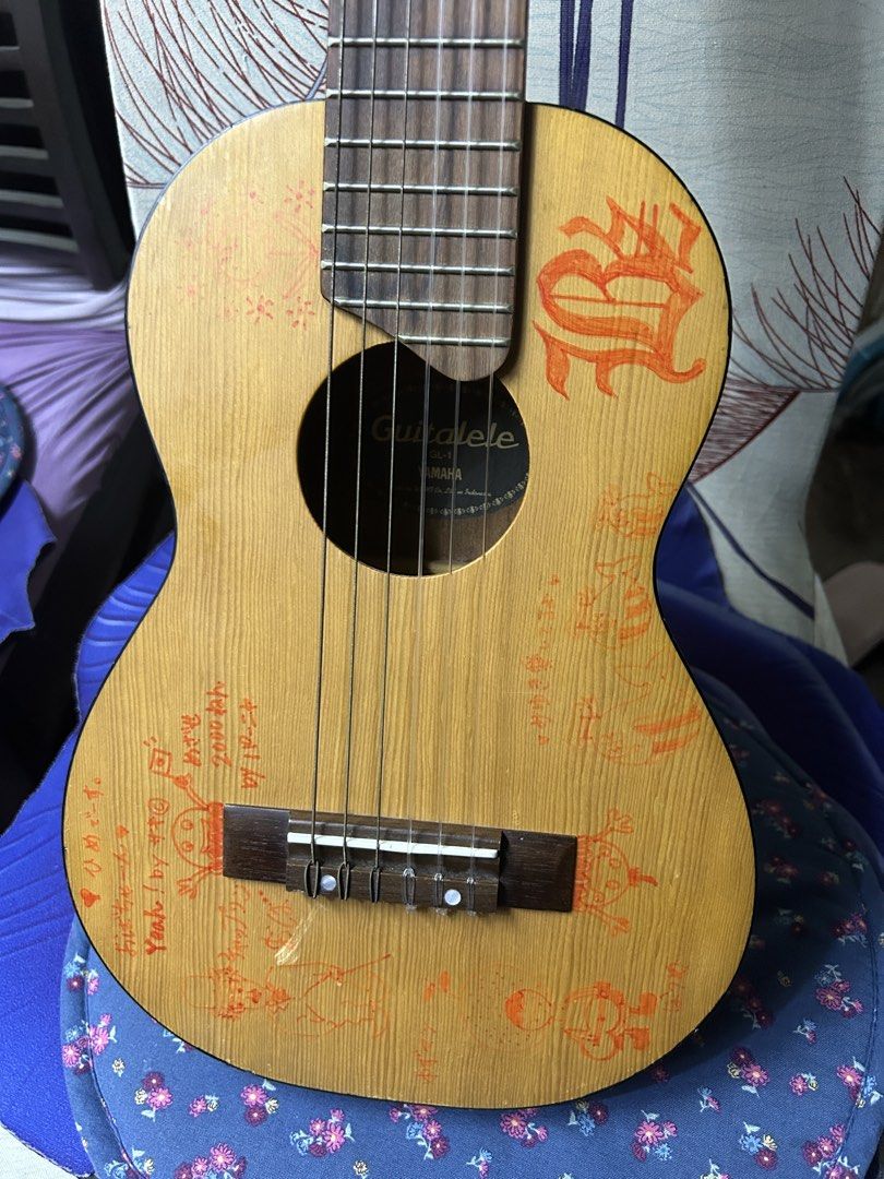 Yamaha Guitarlele GL1 (Category: Musical Instruments) located in Caloocan City. Submitted by guitara1822 (Listing ID 1445049691, Image 2). Description: Guitarlele GL1 Yamaha Design: A unique 6-string nylon guitar sized like a baritone ukulele (17” scale).Tuning: Standard tuning is pitched up to A (A/D/G/C/E/A), which is a 4th higher than a standard guitar.Materials: Features a spruce top, meranti back and sides, and a rosewood fingerboard..