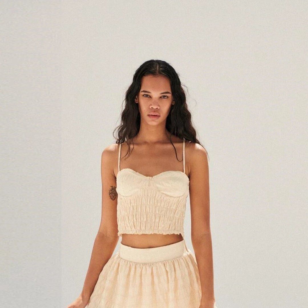 Zara Smocked Bustier Crop Top Beige Size M (Category: Sleeveless) located in Naga. Submitted by fashownts (Listing ID 1445085721, Image 2). Description: - Zara beige smocked bustier crop top - Size: Medium - Adjustable straps - Worn only once - Versatile: pairs well with skirts or high-waisted pants - Ideal for summer outings or nights out.