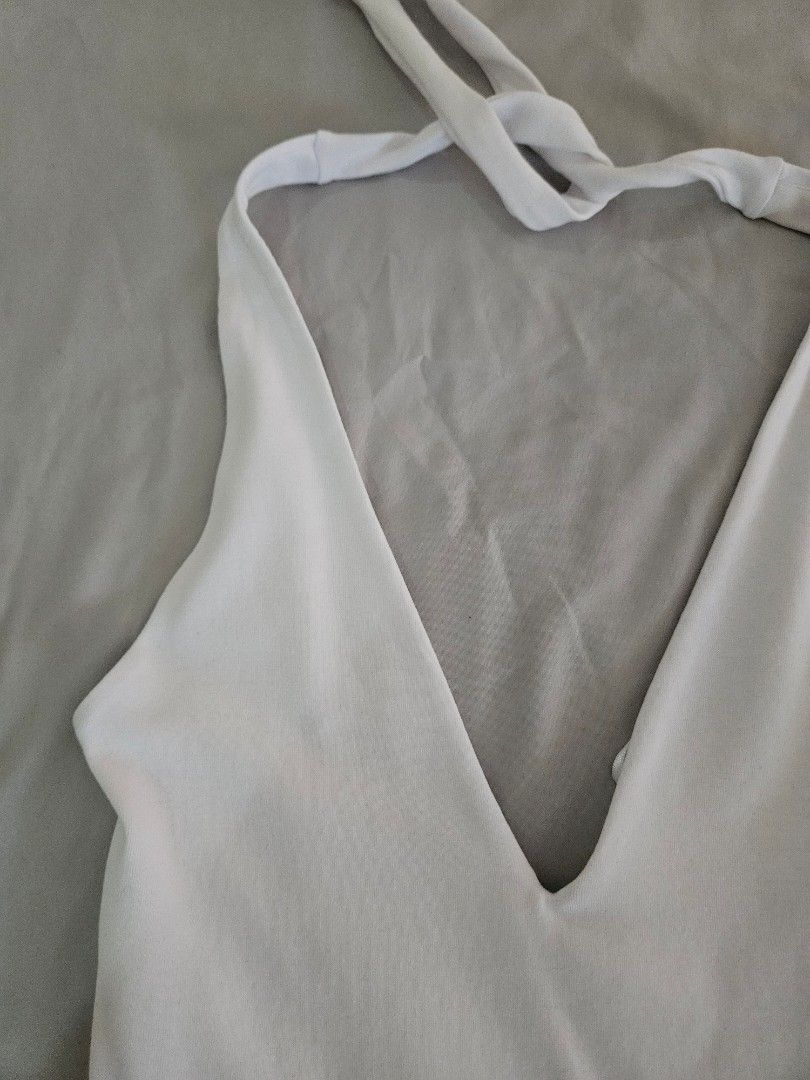 Zara White Halter Neck Dress (Category: Dresses) located in Muntinlupa City. Submitted by theasells (Listing ID 1445069682, Image 2). Description: Zara white halter neck dress. Features a v-neck, tie straps, and a ruffled skirt. Was only worn once! Perfect for a summer/beach trip. RFS: lost weight and doesn't fit me well anymore huhu wouldn't sell otherwise.