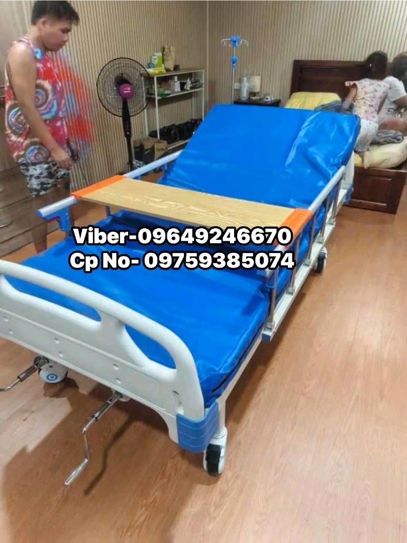 Adjustable Hospital Bed with Side Rails and Tray (Category: Medical Supplies & Tools) located in Manila. Submitted by oplecherly24007 (Listing ID 1445316011, Image 1). Description: - Hospital bed with comfortable blue mattress - Sturdy white/blue side rails for safety - Includes a convenient wooden tray that attaches to the side - Adjustable via a visible crank mechanism - Equipped with wheels for effortless movement - Ready for immediate use.